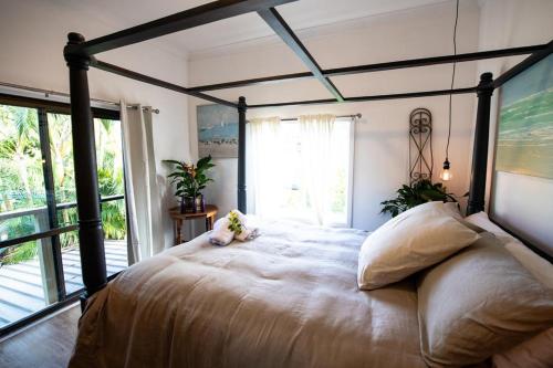 a bedroom with a large bed with a large window at Loft Apartment - 1 Bedroom in Brunswick Heads