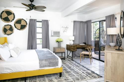 a bedroom with a bed and a desk at Cruz Bay Oasis Walk to Beach & Stunning Views in Enighed