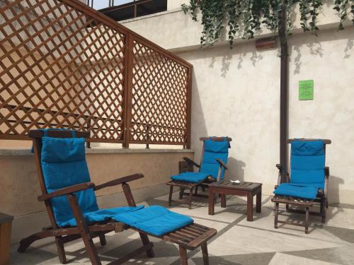 a group of blue chairs sitting on a patio at Hotel dei Mellini in Rome