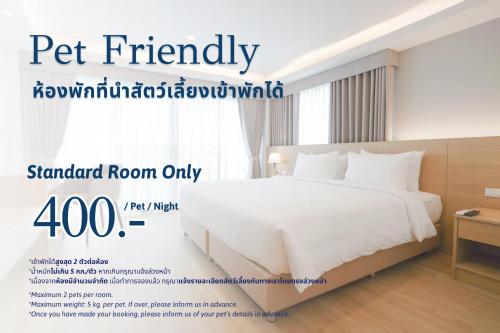 a poster of a bed in a hotel room at The Kite Hotel Bangsaen by Koko in Ban Laem Thaen