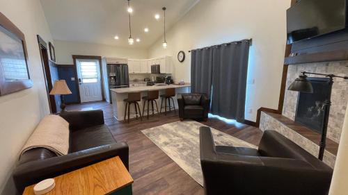 a living room with a couch and a kitchen at Tranquil Retreat in Bozeman