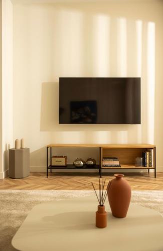 a living room with a tv on a wall at Interlace by Holistays in İncirli