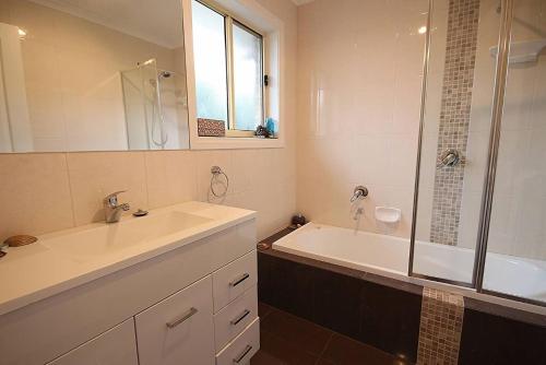 a bathroom with a tub and a sink and a shower at Magik Retreat in Evergreen