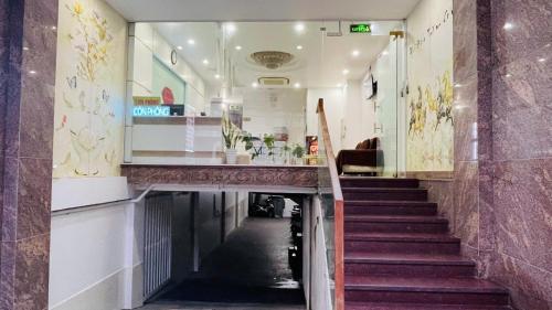 a long hallway with stairs in a building at Ruby Star Hotel Apartment in Vung Tau