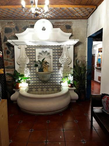 a fountain in the middle of a room with plants at Casa Altavista in Antigua Guatemala