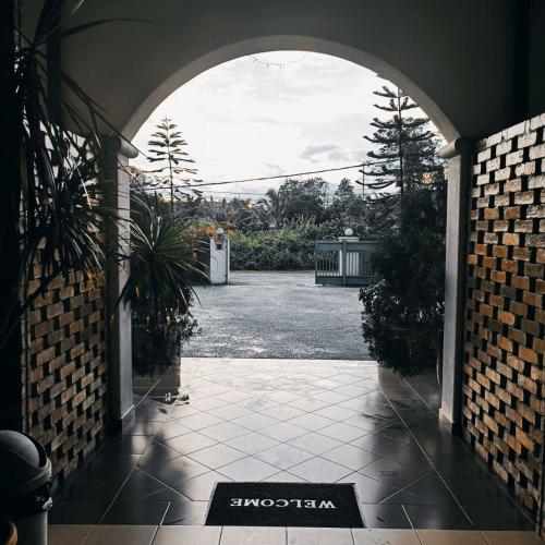 an entry way to a house with an archway at Villa 223 in Kajang