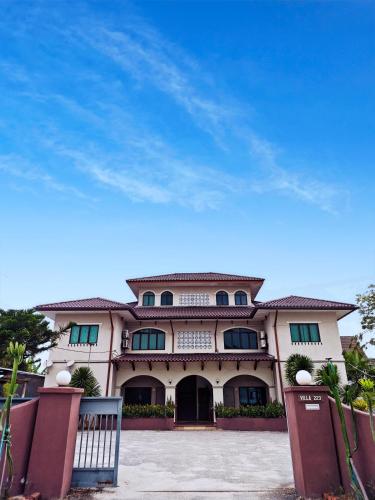 a large building with a fence in front of it at Villa 223 in Kajang