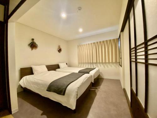 Ένα ή περισσότερα κρεβάτια σε δωμάτιο στο Traditional Japanese style house なにわ鶴橋庵