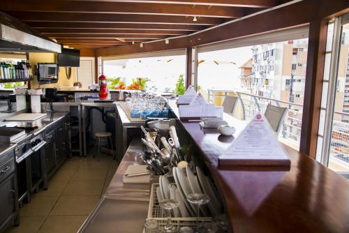 a kitchen with a counter with utensils on it at Hotel Continental Luanda in Luanda