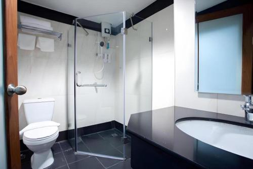 a bathroom with a toilet and a sink and a shower at Vince Sakon in Sakon Nakhon