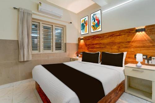 Ένα ή περισσότερα κρεβάτια σε δωμάτιο στο Super Townhouse Green Field Stadium Karyavattom