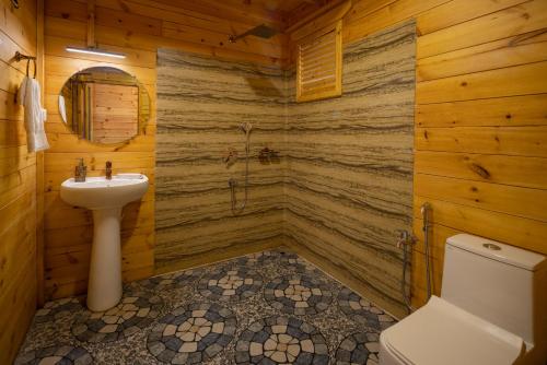 a bathroom with a toilet and a sink at Ourem Palace in Palolem
