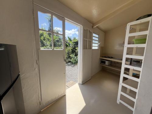 a kitchen with a door and a kitchen with a stove at Beach Studio 24h24 & 7j7 in Petite Île