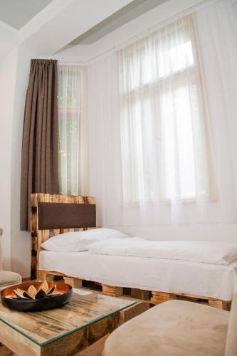 a bedroom with two beds and a window at Hotel Carpe Diem in Siófok