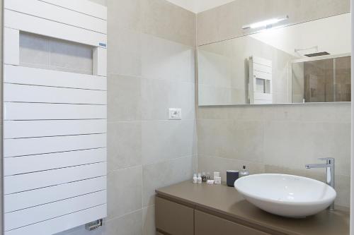 a bathroom with a sink and a mirror at Attico Stema Luxury in Misano Adriatico