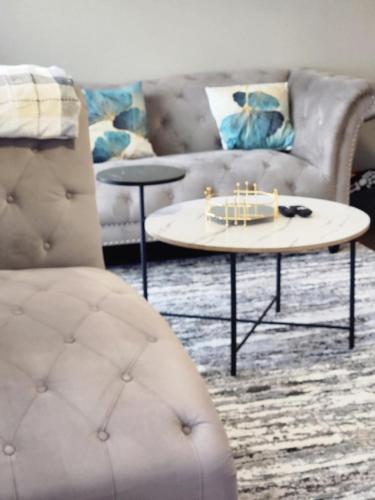 a living room with a couch and a table with candles at Cozy Uptown apartment with Gym and Swimming pool in Charlotte