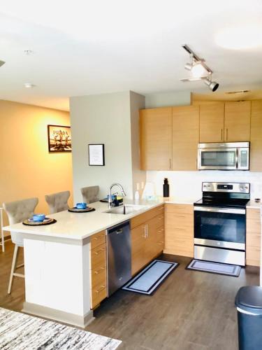 a kitchen with a sink and a stove at Cozy Uptown apartment with Gym and Swimming pool in Charlotte
