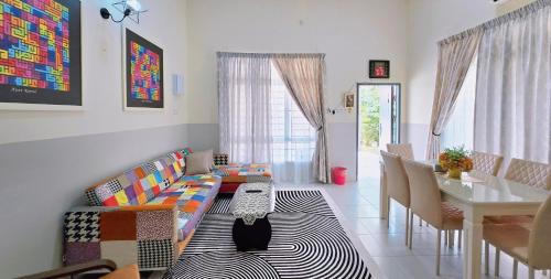 a living room with a couch and a table at Homestay BAYT AL - JAZMY in Kuantan
