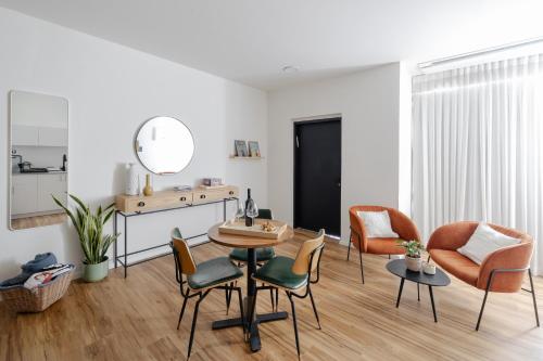a living room with a table and chairs and a mirror at מעגל השמש in Poriyya Illit