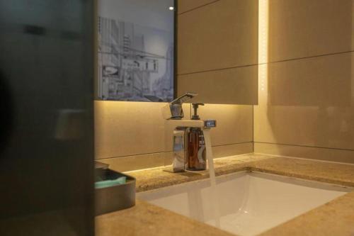 a bathroom sink with a faucet on a counter at City Comfort Inn Quanzhou Wanda in Quanzhou