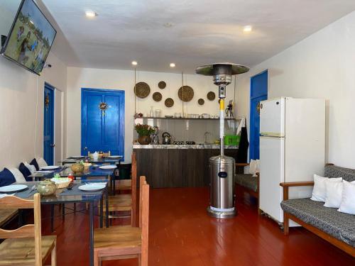 a kitchen and dining room with a table and a refrigerator at Runa House in Cusco