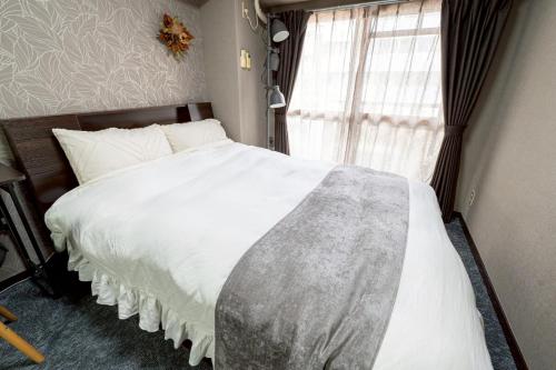 Postel nebo postele na pokoji v ubytování メトロ春日203