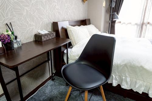 Postel nebo postele na pokoji v ubytování メトロ春日203