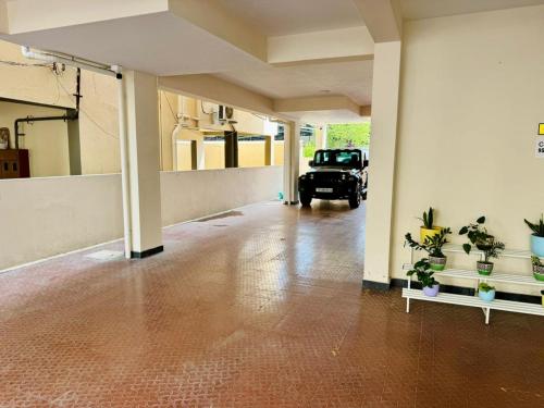 an empty room with a car parked in a garage at Marvee Luxus Stay in Coimbatore