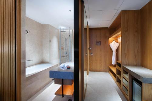 a bathroom with a tub and a sink and a shower at Crowne Plaza Huzhou by IHG in Huzhou