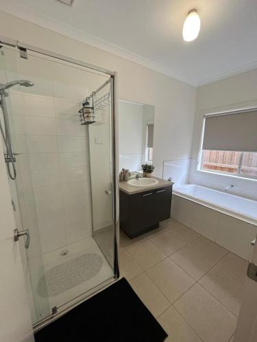 a bathroom with a shower and a sink at My Home in Truganina