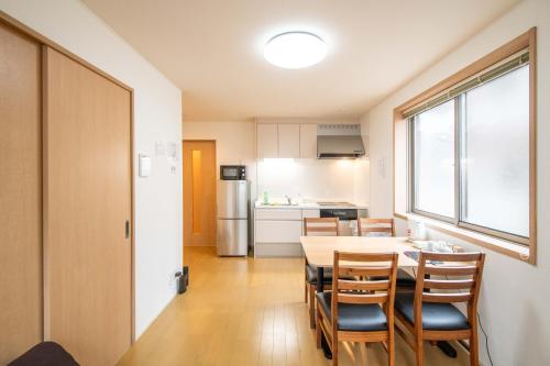 a kitchen and dining room with a table and chairs at Elle Maison大森 102 in Tokyo