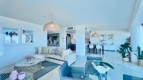 a living room with a couch and a table at Modern 3 Bedroom Al Hadeel West Side Al Rahah Beach in Abu Dhabi