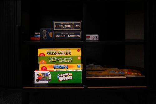 a shelf with some books and some food on it at Tamar Views in Inveresk