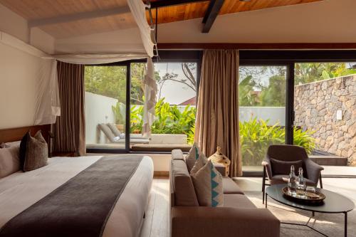 Ένα ή περισσότερα κρεβάτια σε δωμάτιο στο Hemingways Retreat Kigali