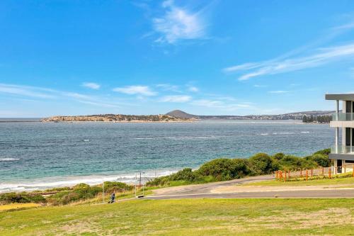 a view of the ocean and a building at 115 Seagull - Beachfront - Wi-Fi - No Linen Included in Hayborough