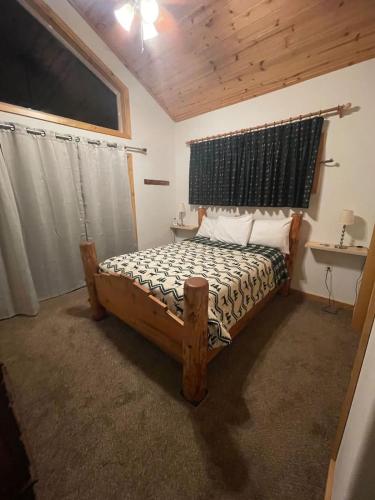 a bedroom with a wooden bed and a window at Mountainside Family Chalet in Yosemite West