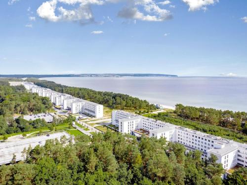 an aerial view of a large white building next to a body of water at Strandresort Prora - Wohnung 213 in Binz