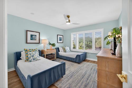 a living room with blue walls and a couch at SG10D: 10D Seagrove Villa in Isle of Palms