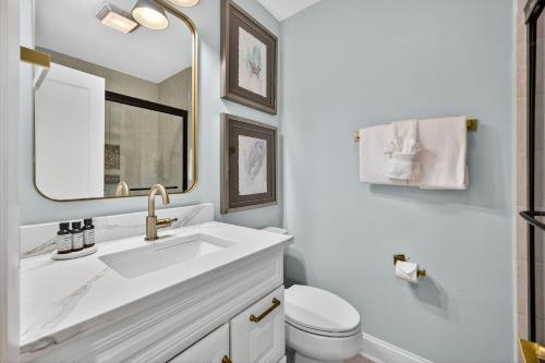 a bathroom with a sink and a toilet and a mirror at SG10D: 10D Seagrove Villa in Isle of Palms