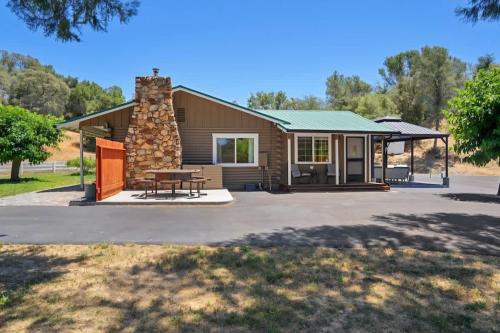 a house with a picnic table in front of it at Modern Cabin Bungalow in Mariposa