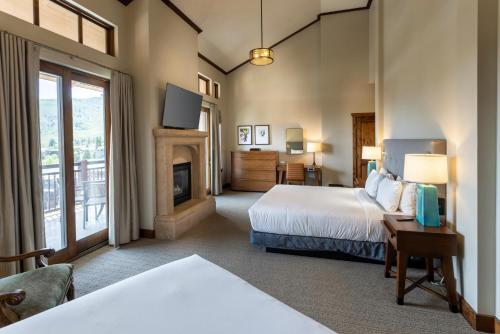 a hotel room with two beds and a fireplace at Hyatt Centric Park City in Park City