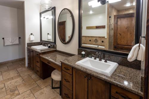 a bathroom with two sinks and two mirrors at Hyatt Centric Park City in Park City