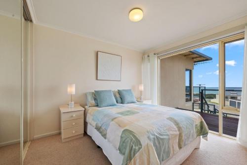 a bedroom with a bed with a view of the ocean at Lovely Unit with Glorious Sea Views in McCracken