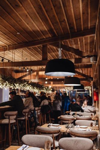a restaurant with many tables and chairs and people at Le Mont in Almaty