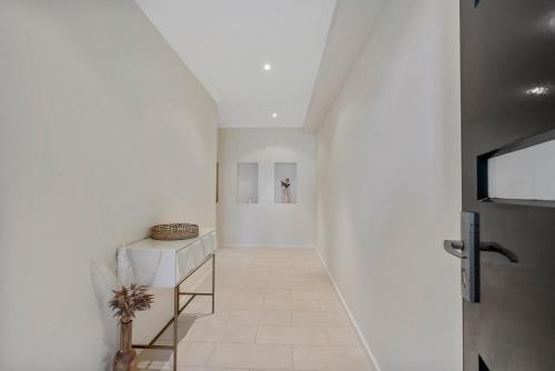 a hallway with white walls and a white floor at Bluffview B&B - Luxury Oceanviews - Wi-Fi - No Linen Included in McCracken