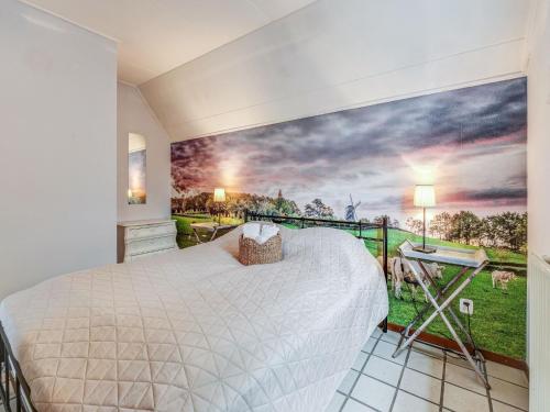 a bedroom with a bed and a painting on the wall at Holiday Homes in Ubachsberg with a Picturesque Garden in Ubachsberg