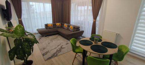 a living room with a couch and a table at Penthouse City View Infinity in Braşov