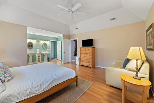 a bedroom with a bed and a couch at MG3080: 3080 Marshgate in Seabrook Island