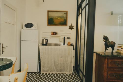 a kitchen with a table and a refrigerator at Tzefania Hotel in Jerusalem