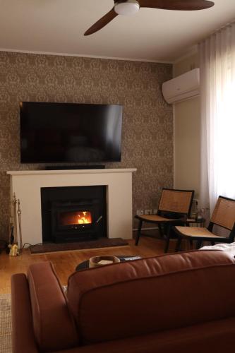 ein Wohnzimmer mit Couch und Kamin in der Unterkunft Vale & Vine in McLaren Vale
